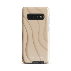 A Sandy Serenity for Samsung encased in a beige, impact-resistant phone case with wavy, textured patterns. Four camera lenses are visible on the back. The lower part of the dual-layer design case displays the text "Statement Cases.