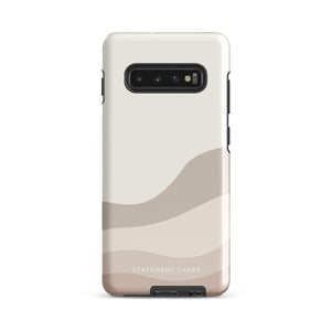 A tough phone case with a beige and cream-colored abstract wavy design. Featuring an impact-resistant dual-layer design, the camera area has three prominent lenses and an LED flash. The brand name "Statement Cases" is subtly printed in white at the bottom of the case.