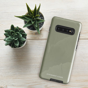 A Pistachio Haze for Samsung with a green phone case featuring a subtle floral pattern. This tough phone case has cutouts for three cameras and a flash, with the brand name "Statement Cases" printed at the bottom. The side buttons are visible, and there's a port at the bottom for easy access.