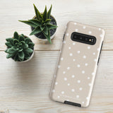 A Classic Nude for Samsung dual-layer smartphone case in beige with white polka dots, designed to fit multiple camera lenses. The impact-resistant phone case also features the text "Statement Cases" printed at the bottom for a stylish touch.