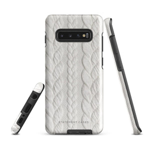 A stylish, impact-resistant phone case with a textured white braided design, covering the back of a smartphone. The dual-layer design features cutouts for the camera and buttons, and "Cozy Knit Bliss for Samsung" by Statement Cases is embossed at the bottom.