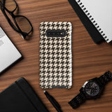 A Statement Cases Timeless Houndstooth for Samsung featuring a black and beige houndstooth pattern. The camera cutout at the top rear is designed for a triple-lens camera. With its dual-layer design and slim profile, this impact-resistant case also boasts a glossy finish.