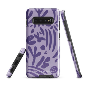 Introducing the Luna Morada for Samsung, a striking smartphone case from Statement Cases. This decorative purple cover boasts abstract floral and organic patterns in darker hues and is designed to absorb shocks. The impact-resistant case features a camera cutout that accommodates five lenses, with the brand name "STATEMENT CASES" elegantly printed at the bottom center.