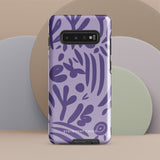 Introducing the Luna Morada for Samsung, a striking smartphone case from Statement Cases. This decorative purple cover boasts abstract floral and organic patterns in darker hues and is designed to absorb shocks. The impact-resistant case features a camera cutout that accommodates five lenses, with the brand name "STATEMENT CASES" elegantly printed at the bottom center.