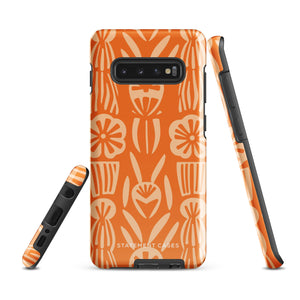 This stylish smartphone accessory, the Savannah Ardiente for Samsung by Statement Cases, features a shock-absorbing, colorful patterned case adorned with abstract flower designs in beige on an orange background. This impact-resistant phone case wraps around the back of your device, providing robust protection for its multiple camera lenses in the corner.