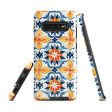 The Mediterranean Bloom for Samsung by Statement Cases features intricate, colorful floral patterns in blue, orange, and yellow. The design covers the entire back of the case, surrounding the camera cutout. Shock-absorbing and impact-resistant, it ensures protection while the brand "Statement Cases" is subtly printed near the bottom.