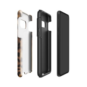A smartphone with a leopard print, dual-layer design phone case featuring four camera lenses on the back is displayed against a white background. The bottom of the tough phone case has the brand name "Statement Cases" in white letters. The product name is "Daring Cheetah Fur for Samsung".