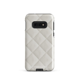 A Quilted Delight for Samsung with a quilted pattern in a light cream color made from impact-resistant materials. The case has a cutout for the camera module with four lenses and a flash. "Statement Cases" is branded at the bottom in white text.