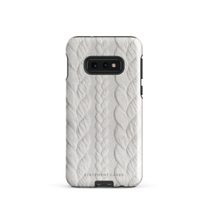 A stylish, impact-resistant phone case with a textured white braided design, covering the back of a smartphone. The dual-layer design features cutouts for the camera and buttons, and "Cozy Knit Bliss for Samsung" by Statement Cases is embossed at the bottom.