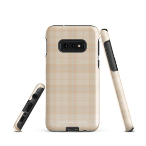 A smartphone with an impact-resistant beige plaid phone case featuring subtle light blue accents. The camera, flash, and sensor modules are visible at the top. The bottom part of the case has the text "Sophisticated Plaid for Samsung" printed on it by Statement Cases.