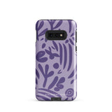 Introducing the Luna Morada for Samsung, a striking smartphone case from Statement Cases. This decorative purple cover boasts abstract floral and organic patterns in darker hues and is designed to absorb shocks. The impact-resistant case features a camera cutout that accommodates five lenses, with the brand name "STATEMENT CASES" elegantly printed at the bottom center.