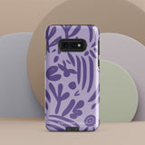 Introducing the Luna Morada for Samsung, a striking smartphone case from Statement Cases. This decorative purple cover boasts abstract floral and organic patterns in darker hues and is designed to absorb shocks. The impact-resistant case features a camera cutout that accommodates five lenses, with the brand name "STATEMENT CASES" elegantly printed at the bottom center.