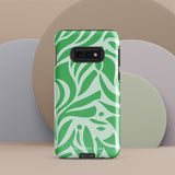 The Selva Verde for Samsung, a product by Statement Cases, is a durable, dual-layer phone case adorned with a green and white leafy design. The back of the case includes a camera cutout, and the bottom is printed with "Statement Cases.