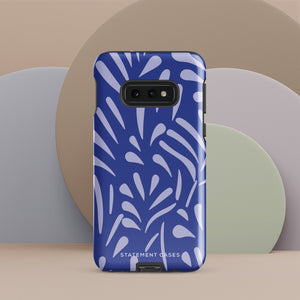 The Mariposa Azul for Samsung smartphone case from Statement Cases is adorned with an impact-resistant design featuring light purple abstract shapes on a blue background. This dual-layer case proudly displays the text "STATEMENT CASES" at the bottom, ensuring that the camera lenses and buttons of your phone remain clearly visible.