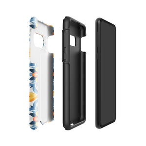 The Mediterranean Bloom for Samsung by Statement Cases features intricate, colorful floral patterns in blue, orange, and yellow. The design covers the entire back of the case, surrounding the camera cutout. Shock-absorbing and impact-resistant, it ensures protection while the brand "Statement Cases" is subtly printed near the bottom.