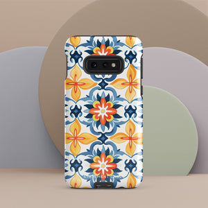 The Mediterranean Bloom for Samsung by Statement Cases features intricate, colorful floral patterns in blue, orange, and yellow. The design covers the entire back of the case, surrounding the camera cutout. Shock-absorbing and impact-resistant, it ensures protection while the brand "Statement Cases" is subtly printed near the bottom.