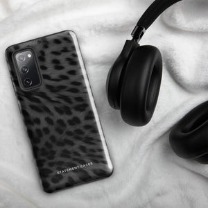 A Nocturnal Hunter Fur for Samsung with a black and gray leopard print phone case featuring a dual-layer design. The camera module has five lenses and a flash. The text "STATEMENT CASES" is written at the bottom of this impact-resistant case.