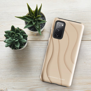 A Sandy Serenity for Samsung encased in a beige, impact-resistant phone case with wavy, textured patterns. Four camera lenses are visible on the back. The lower part of the dual-layer design case displays the text "Statement Cases.