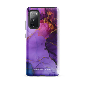 The Golden Orchid Marble for Samsung by Statement Cases is a smartphone adorned with a vibrant, abstract phone case showcasing a mix of purple, pink, and gold colors. Crafted from impact-resistant materials, it features a camera module with four lenses and a flash. At the bottom of the shock-absorbing phone case, you’ll find the text "STATEMENT CASES" in white.