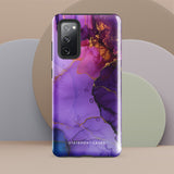 The Golden Orchid Marble for Samsung by Statement Cases is a smartphone adorned with a vibrant, abstract phone case showcasing a mix of purple, pink, and gold colors. Crafted from impact-resistant materials, it features a camera module with four lenses and a flash. At the bottom of the shock-absorbing phone case, you’ll find the text "STATEMENT CASES" in white.