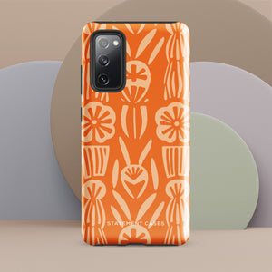 This stylish smartphone accessory, the Savannah Ardiente for Samsung by Statement Cases, features a shock-absorbing, colorful patterned case adorned with abstract flower designs in beige on an orange background. This impact-resistant phone case wraps around the back of your device, providing robust protection for its multiple camera lenses in the corner.