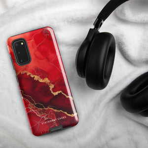 A red and black Scarlet Marble for Samsung with a marble-like pattern and gold accents, designed for a phone with multiple rear cameras. This tough phone case features an impact-resistant, dual-layer design and showcases the brand name "Statement Cases" near the bottom.