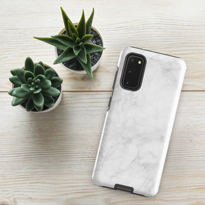 A dual-layer design smartphone case with a white marble pattern features three large camera lenses and a smaller one on the back. "Statement Cases" is subtly printed near the bottom. The minimalistic, matte finish offers impact-resistant protection with style.