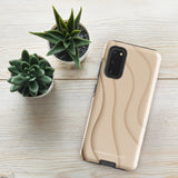 A Sandy Serenity for Samsung encased in a beige, impact-resistant phone case with wavy, textured patterns. Four camera lenses are visible on the back. The lower part of the dual-layer design case displays the text "Statement Cases.