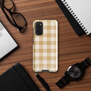 A beige and white checkered phone case is shown. Designed to fit a smartphone with a horizontal dual-camera setup, it features "STATEMENT CASES" printed at the bottom. This impact-resistant phone case offers both style and protection.Product Name: Gingham Grace for Samsung Brand Name: Statement Cases