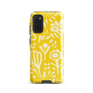 The Sol Dorado for Samsung by Statement Cases is a durable phone case featuring a bright yellow background adorned with an abstract white floral pattern, showcasing various flowers and leaves. Near the bottom edge, the text "STATEMENT CASE" highlights its dual-layer design for enhanced durability.