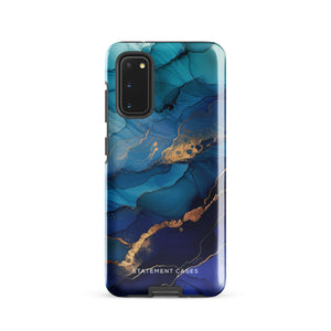 A Samsung smartphone adorned with the Midnight Wave Marble—a vibrant, blue and gold marble-patterned dual-layer phone case. Featuring multiple camera lenses at the top left corner, this impact-resistant case is elegantly labeled "Statement Cases" in white text at the bottom. The design showcases fluid, swirling layers with metallic accents.