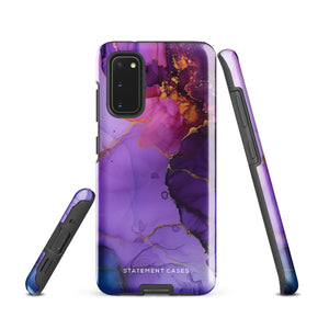 The Golden Orchid Marble for Samsung by Statement Cases is a smartphone adorned with a vibrant, abstract phone case showcasing a mix of purple, pink, and gold colors. Crafted from impact-resistant materials, it features a camera module with four lenses and a flash. At the bottom of the shock-absorbing phone case, you’ll find the text "STATEMENT CASES" in white.