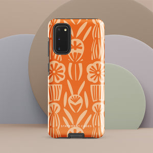 This stylish smartphone accessory, the Savannah Ardiente for Samsung by Statement Cases, features a shock-absorbing, colorful patterned case adorned with abstract flower designs in beige on an orange background. This impact-resistant phone case wraps around the back of your device, providing robust protection for its multiple camera lenses in the corner.