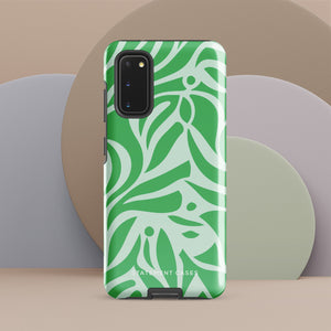 The Selva Verde for Samsung, a product by Statement Cases, is a durable, dual-layer phone case adorned with a green and white leafy design. The back of the case includes a camera cutout, and the bottom is printed with "Statement Cases.