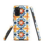 The Mediterranean Bloom for Samsung by Statement Cases features intricate, colorful floral patterns in blue, orange, and yellow. The design covers the entire back of the case, surrounding the camera cutout. Shock-absorbing and impact-resistant, it ensures protection while the brand "Statement Cases" is subtly printed near the bottom.