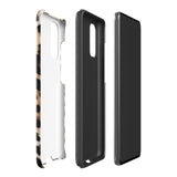 A tough phone case with a leopard print design is displayed. The dual-layer design features black and brown spots on a tan background, mimicking leopard fur. The text "Statement Cases" is printed on the lower part of the impact-resistant case. This is the Mighty Jaguar Fur for Samsung by Statement Cases.