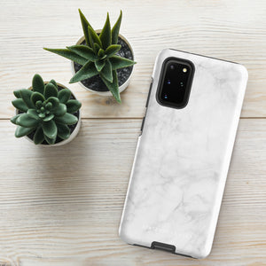 A dual-layer design smartphone case with a white marble pattern features three large camera lenses and a smaller one on the back. "Statement Cases" is subtly printed near the bottom. The minimalistic, matte finish offers impact-resistant protection with style.