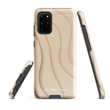 A Sandy Serenity for Samsung encased in a beige, impact-resistant phone case with wavy, textured patterns. Four camera lenses are visible on the back. The lower part of the dual-layer design case displays the text "Statement Cases.