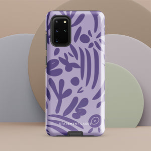 Introducing the Luna Morada for Samsung, a striking smartphone case from Statement Cases. This decorative purple cover boasts abstract floral and organic patterns in darker hues and is designed to absorb shocks. The impact-resistant case features a camera cutout that accommodates five lenses, with the brand name "STATEMENT CASES" elegantly printed at the bottom center.