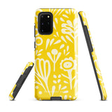 The Sol Dorado for Samsung by Statement Cases is a durable phone case featuring a bright yellow background adorned with an abstract white floral pattern, showcasing various flowers and leaves. Near the bottom edge, the text "STATEMENT CASE" highlights its dual-layer design for enhanced durability.