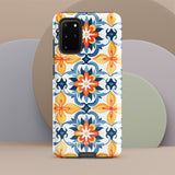 The Mediterranean Bloom for Samsung by Statement Cases features intricate, colorful floral patterns in blue, orange, and yellow. The design covers the entire back of the case, surrounding the camera cutout. Shock-absorbing and impact-resistant, it ensures protection while the brand "Statement Cases" is subtly printed near the bottom.