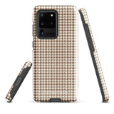 A Samsung smartphone with a beige and brown houndstooth patterned, impact-resistant case from Statement Cases. The phone features multiple cameras on the upper left side of its back. This tough Classic Houndstooth for Samsung phone case has a sleek, dual-layer design with precise cutouts for the cameras and buttons.