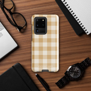 A beige and white checkered phone case is shown. Designed to fit a smartphone with a horizontal dual-camera setup, it features "STATEMENT CASES" printed at the bottom. This impact-resistant phone case offers both style and protection.Product Name: Gingham Grace for Samsung Brand Name: Statement Cases