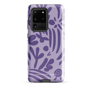 Introducing the Luna Morada for Samsung, a striking smartphone case from Statement Cases. This decorative purple cover boasts abstract floral and organic patterns in darker hues and is designed to absorb shocks. The impact-resistant case features a camera cutout that accommodates five lenses, with the brand name "STATEMENT CASES" elegantly printed at the bottom center.