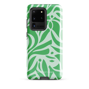 The Selva Verde for Samsung, a product by Statement Cases, is a durable, dual-layer phone case adorned with a green and white leafy design. The back of the case includes a camera cutout, and the bottom is printed with "Statement Cases.