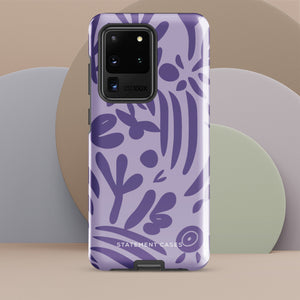 Introducing the Luna Morada for Samsung, a striking smartphone case from Statement Cases. This decorative purple cover boasts abstract floral and organic patterns in darker hues and is designed to absorb shocks. The impact-resistant case features a camera cutout that accommodates five lenses, with the brand name "STATEMENT CASES" elegantly printed at the bottom center.