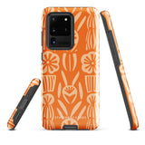 This stylish smartphone accessory, the Savannah Ardiente for Samsung by Statement Cases, features a shock-absorbing, colorful patterned case adorned with abstract flower designs in beige on an orange background. This impact-resistant phone case wraps around the back of your device, providing robust protection for its multiple camera lenses in the corner.