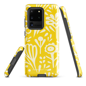 The Sol Dorado for Samsung by Statement Cases is a durable phone case featuring a bright yellow background adorned with an abstract white floral pattern, showcasing various flowers and leaves. Near the bottom edge, the text "STATEMENT CASE" highlights its dual-layer design for enhanced durability.