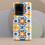 The Mediterranean Bloom for Samsung by Statement Cases features intricate, colorful floral patterns in blue, orange, and yellow. The design covers the entire back of the case, surrounding the camera cutout. Shock-absorbing and impact-resistant, it ensures protection while the brand "Statement Cases" is subtly printed near the bottom.