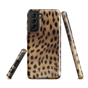 A smartphone with a leopard print, dual-layer design phone case featuring four camera lenses on the back is displayed against a white background. The bottom of the tough phone case has the brand name "Statement Cases" in white letters. The product name is "Daring Cheetah Fur for Samsung".